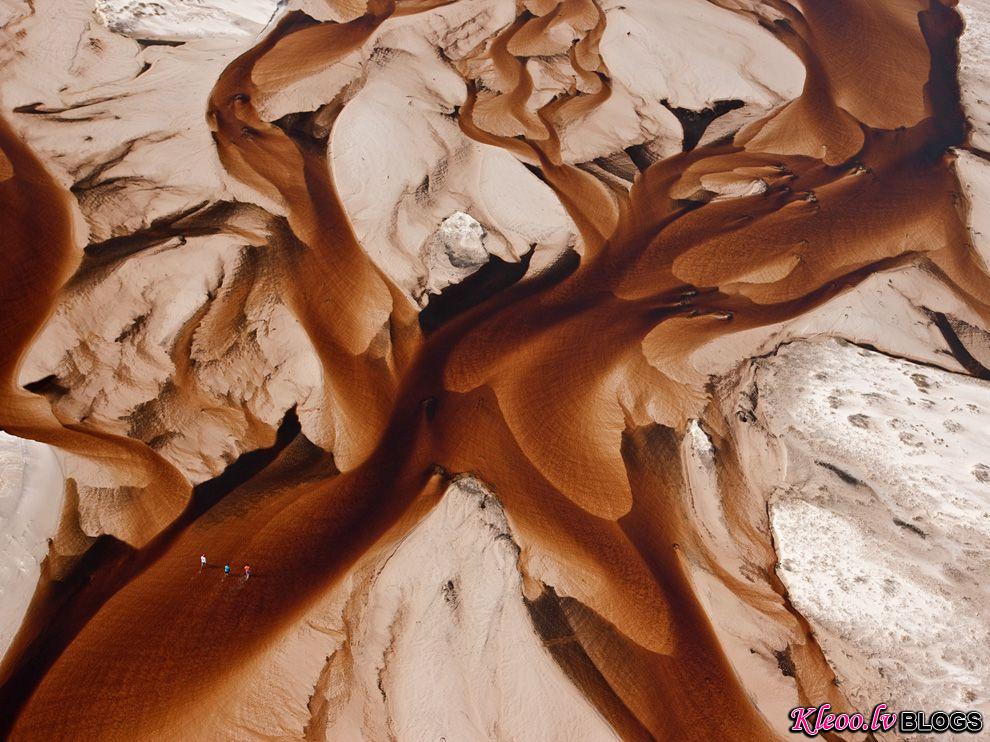 Photo: Tannin-darkened waters of Rio Negro flowing across the sand on the coast of Brazil
