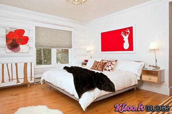 Red accents in a white bedroom