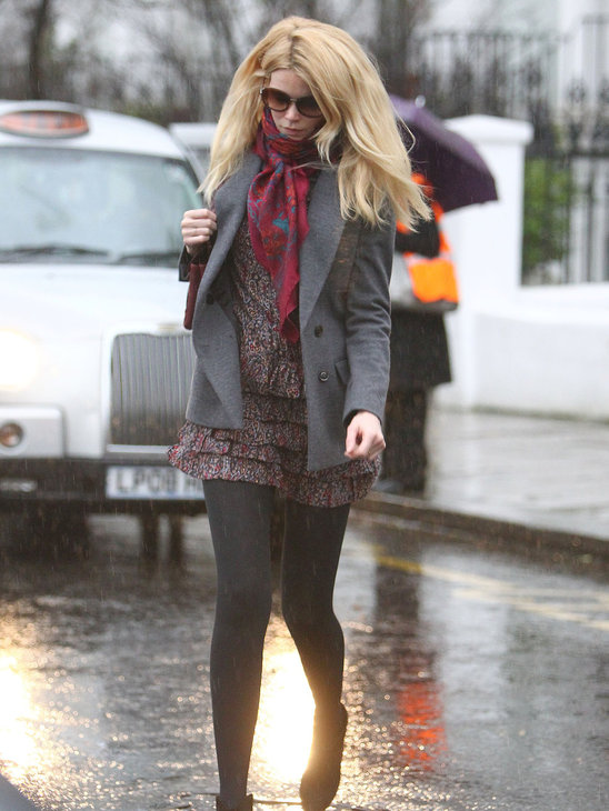 Claudia Schiffer is ever stylish in London's rainy weather, but what's with sunglasses in the rain?